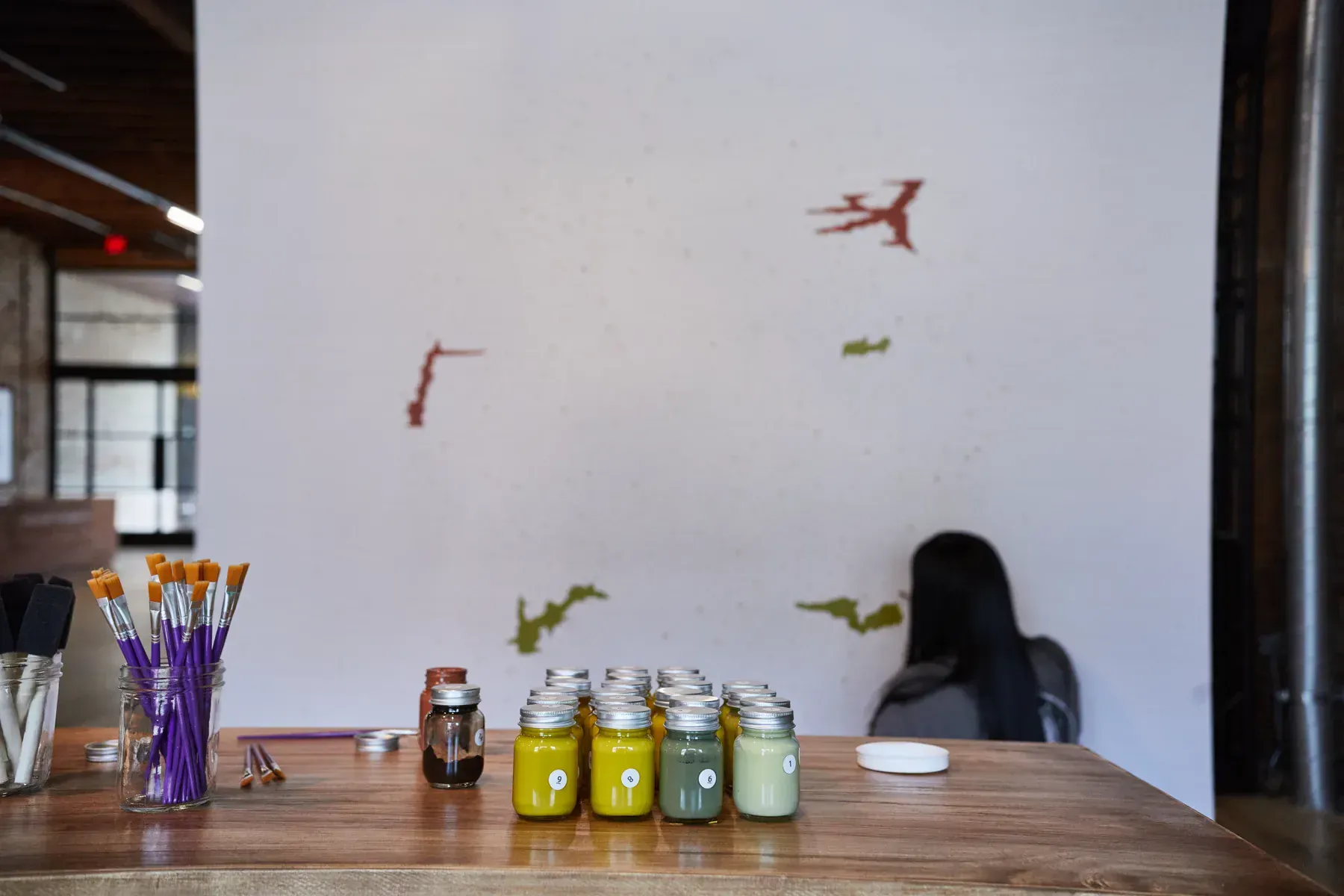 Ed Sheeran Subtract paint-by-number mural beginning to fill with yellow, green, and brown paint