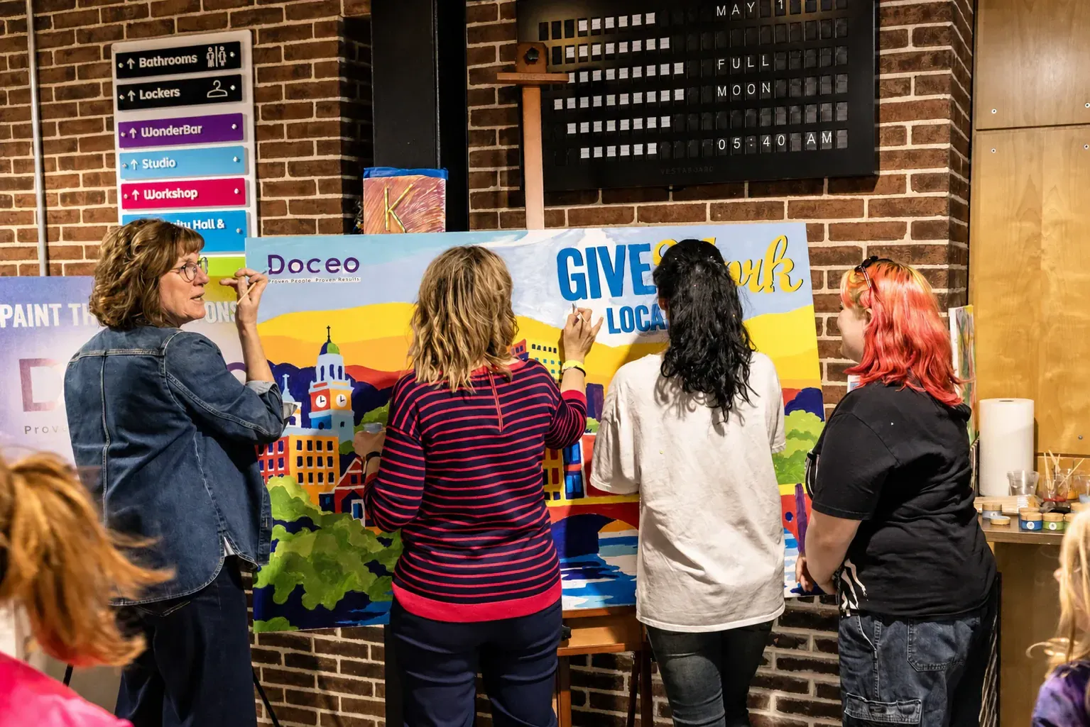 Guests painting a colorful Give Local York paint-by-number mural together