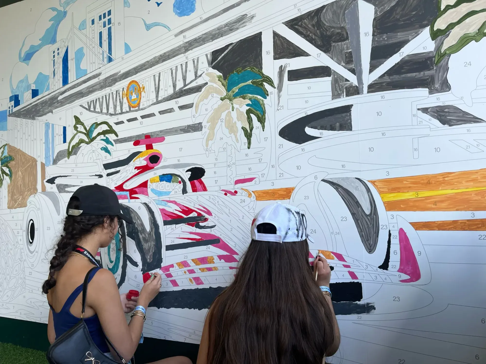 Guests painting a custom motorsports paint-by-number mural at The Art Club in Miami