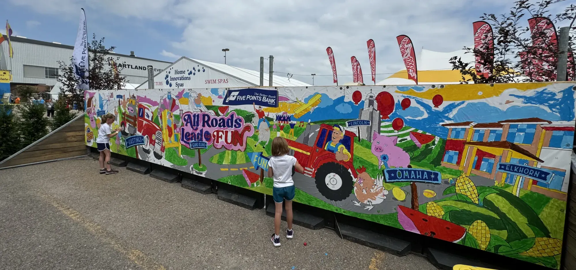 Nebraska State Fair visitors painting a 30-foot paint-by-number mural sponsored by Five Points Bank